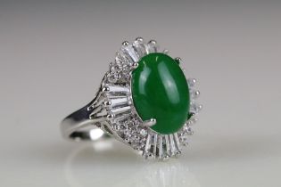 A 925 sterling silver ladies dress ring of classical style with oval green centre stone with clear