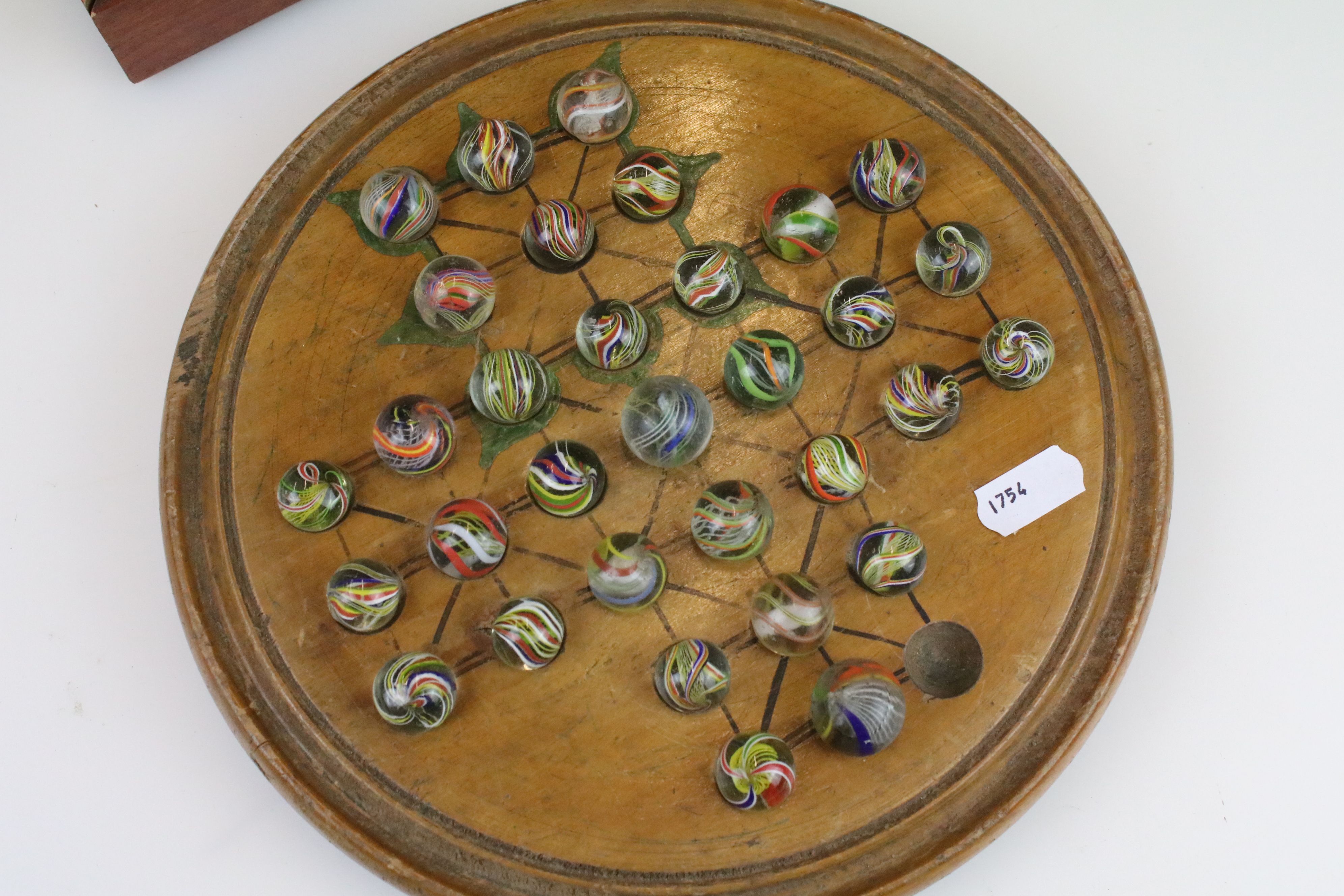 An antique carved wooden solitaire board complete with antique marbles. - Image 2 of 4