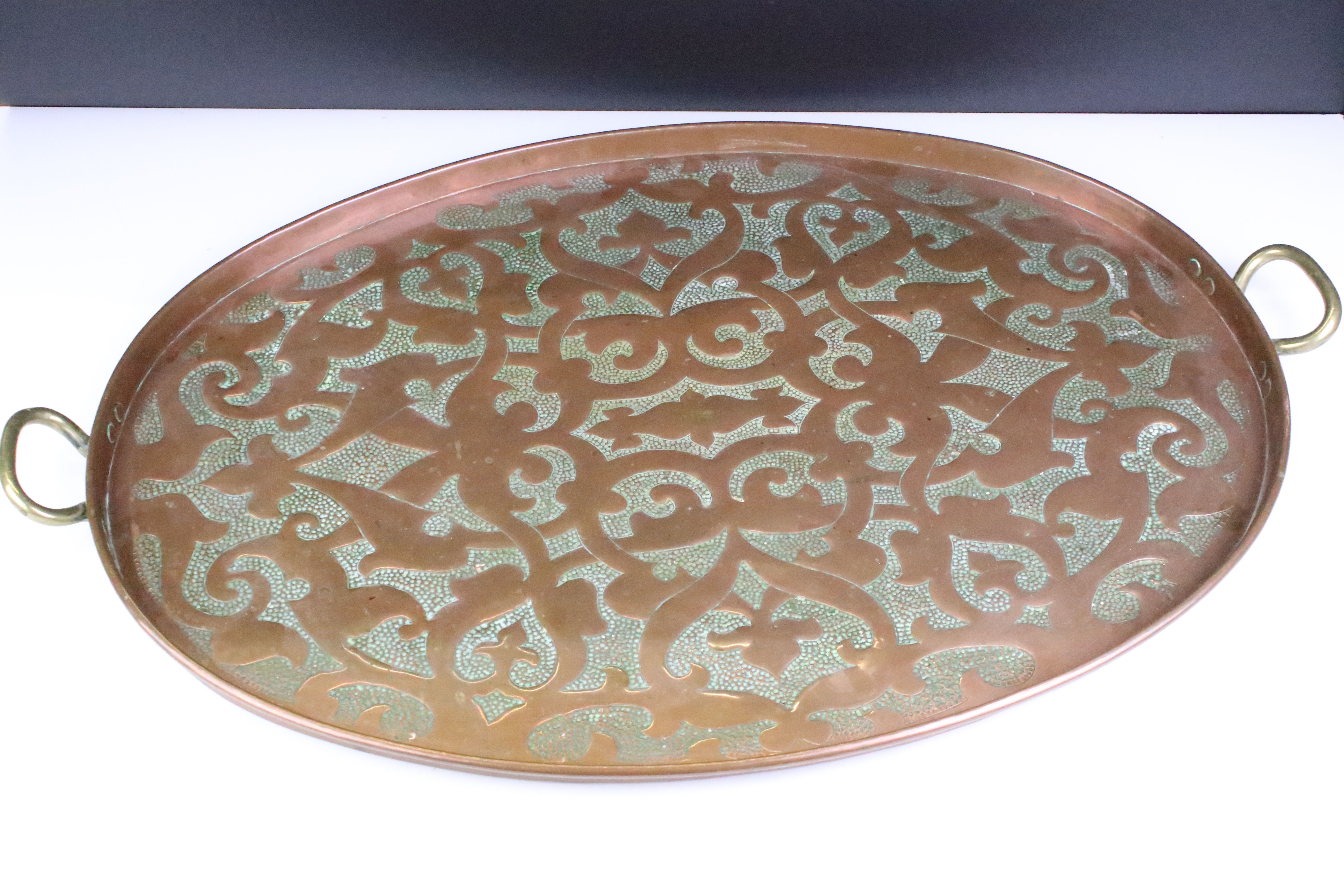 Early 20th Century hammered copper tray having stylised hammered detailing to tray and twin brass