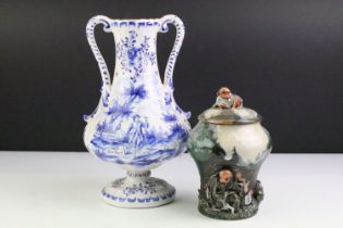 Delft blue and white tin glazed twin handled vase having hand painted detailing featuring a