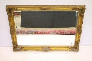 Large gilt framed bevelled edged rectangular wall mirror with scroll detail, approx 104cm W x 75cm H