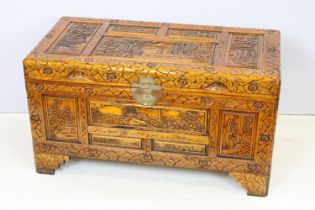 20th Century Chinese carved trunk having panelled detailing with hinged lid raised on bracket