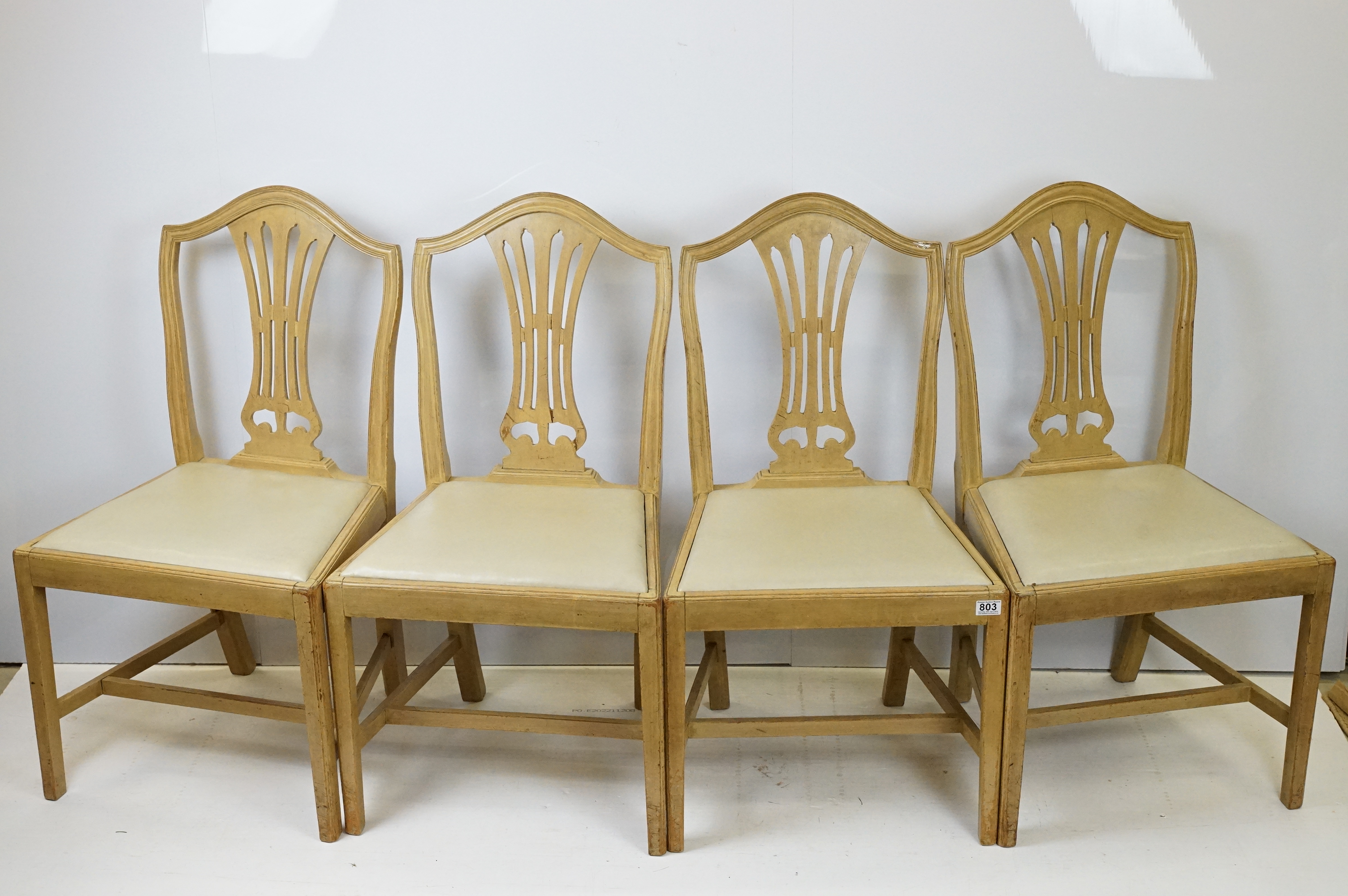 Group of four 20th Century stained oak dining chairs with cream drop in seats.