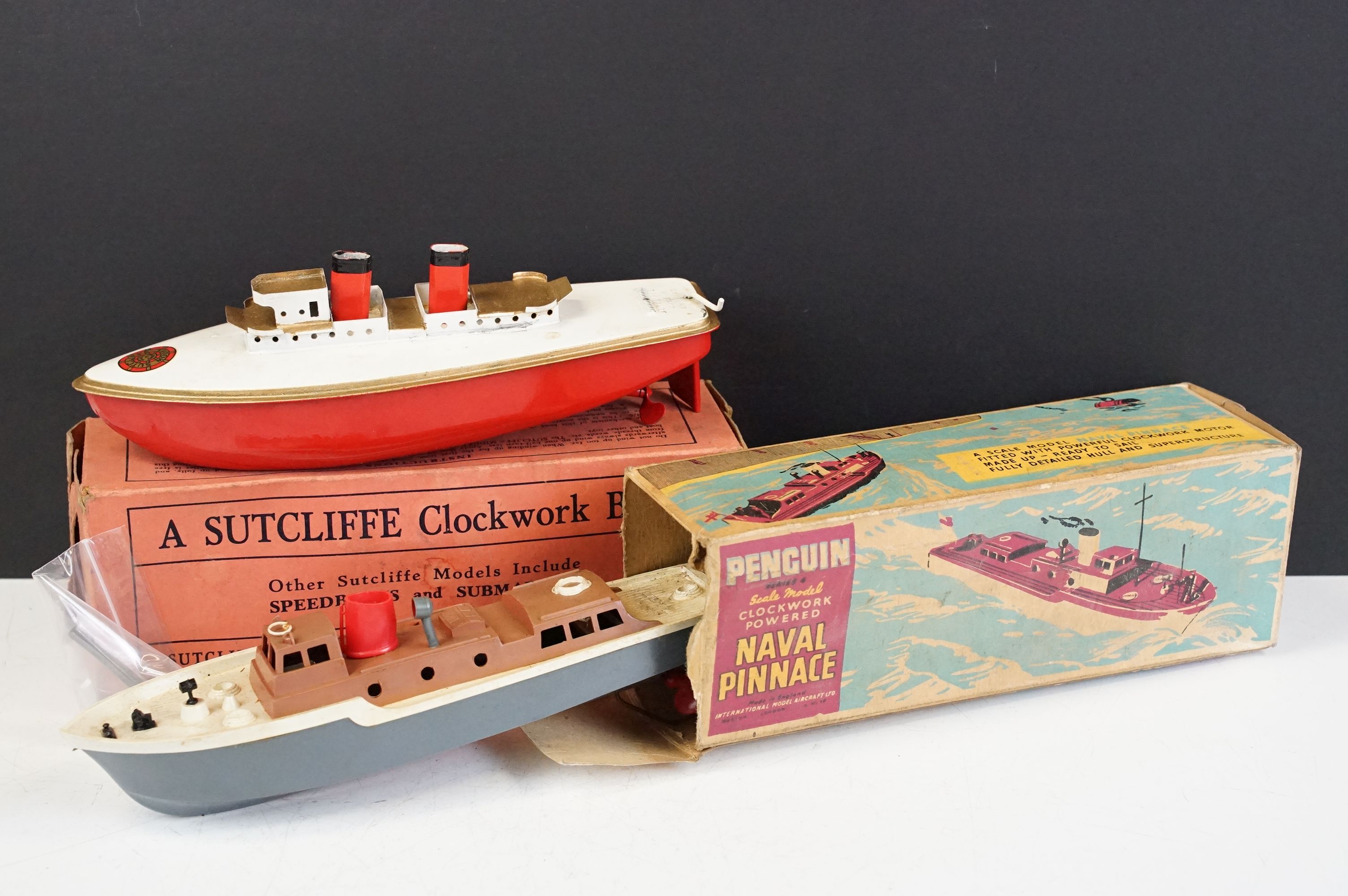 Two boxed model boats to include Sutcliffe tin plate Clockwork Viking Boat in red / white with key