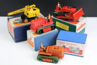 Four boxed Dinky Supertoys diecast models to include 2 x 563 Heavy Tractor (one in red with green