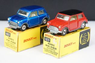 Two boxed Dinky 183 Morris Mini Minor diecast models in colour variants of metallic blue and red