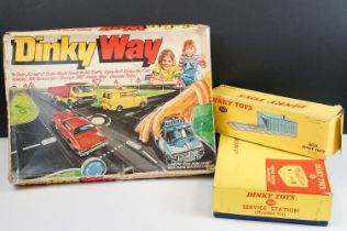 Four boxed Dinky items to include printed card roadway and road signs, missing instructions and 4