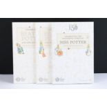 A collection of Beatrix Potter 50p coins within three Royal Mint collectors folders.