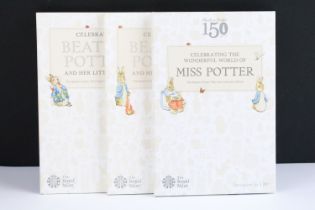 A collection of Beatrix Potter 50p coins within three Royal Mint collectors folders.