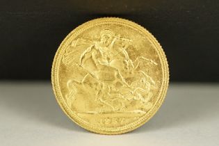 A British Queen Elizabeth II 1957 gold full sovereign coin.