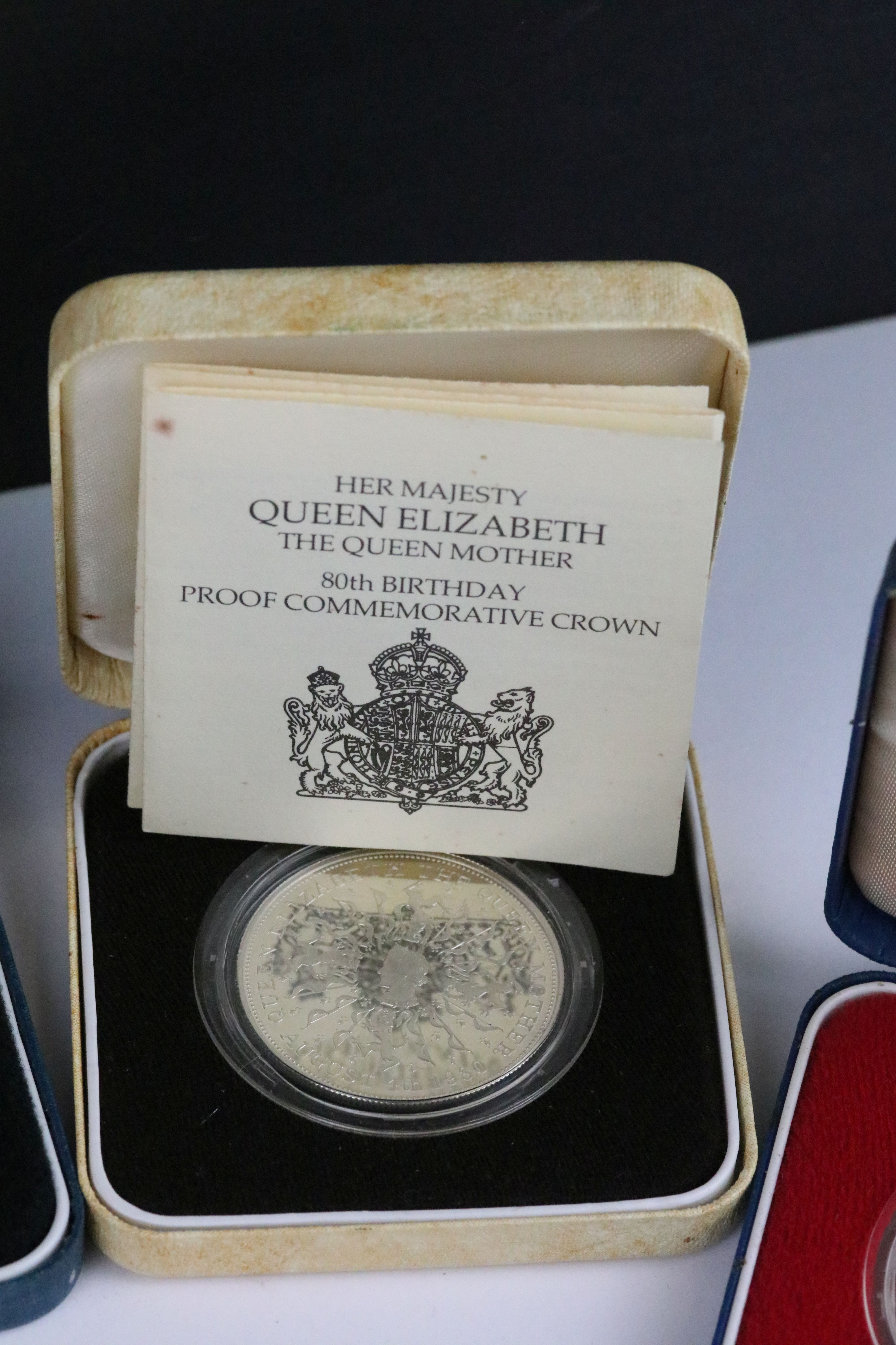 A collection of four Royal Mint silver proof crown coins all encapsulated within display cases. - Image 6 of 9