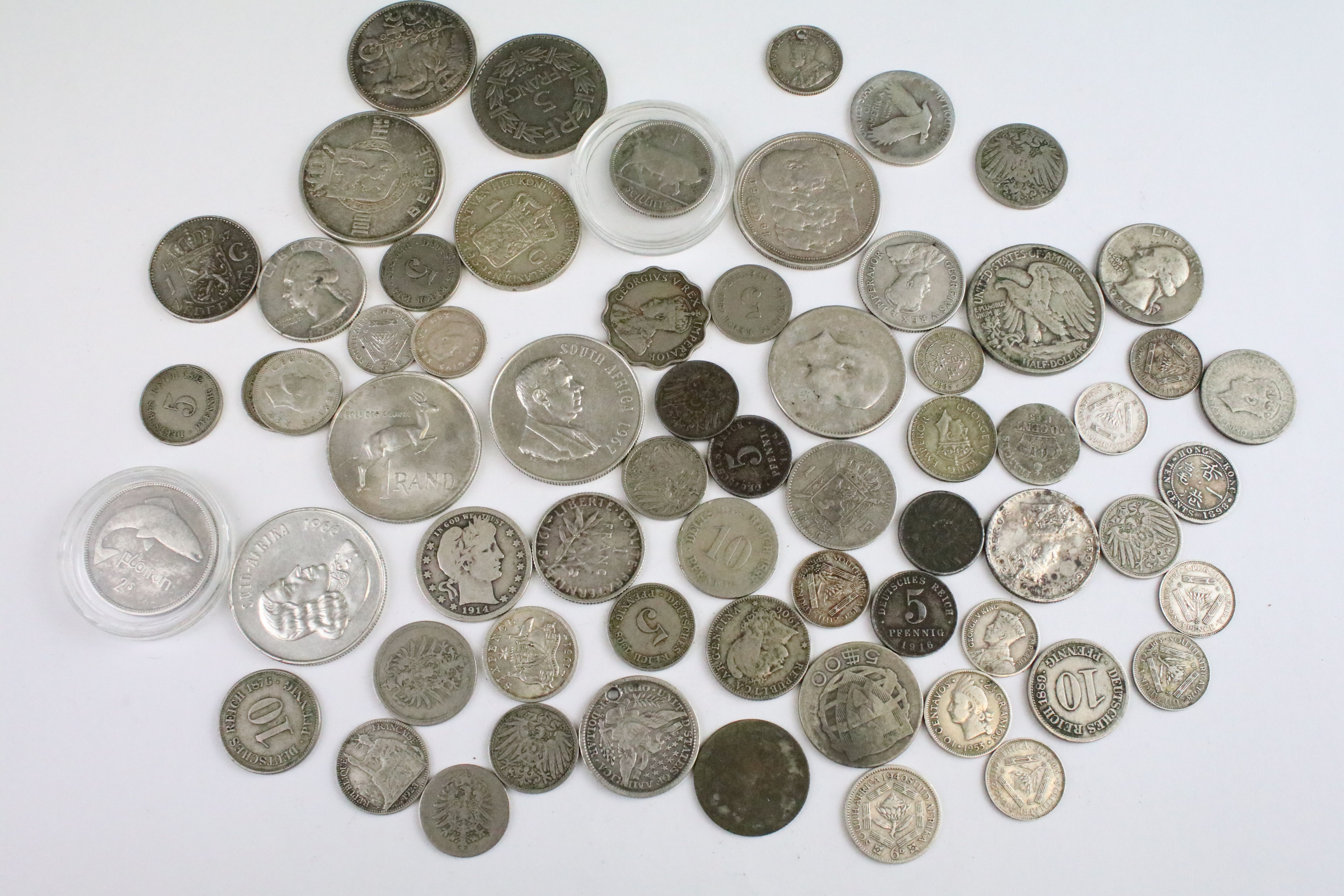 A collection of circulated world silver coins to include United States, German and India examples.