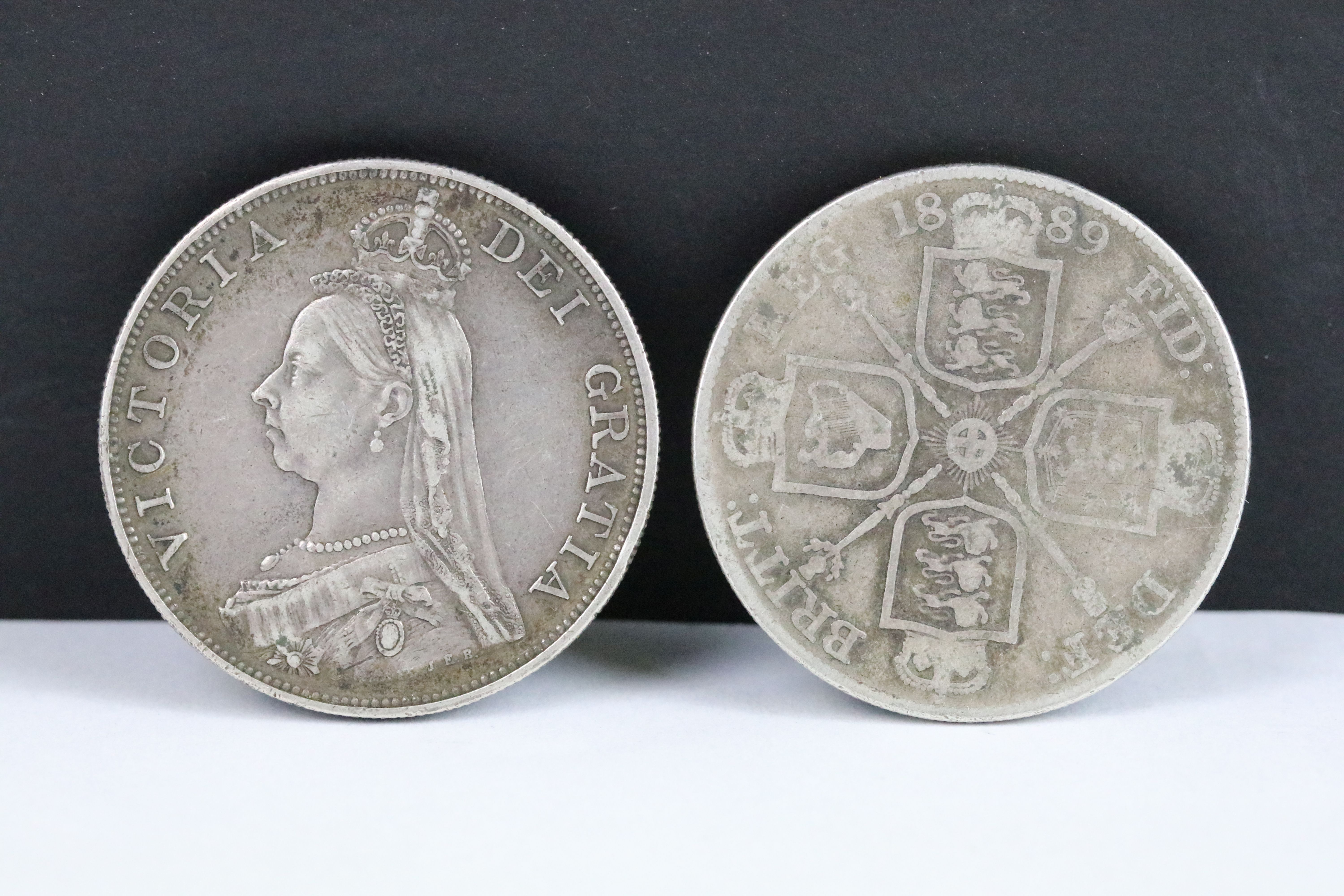 Two British Queen Victoria pre decimal silver double florin coins to include 1887 and 1889 examples.