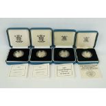 A collection of four Royal Mint silver proof £1 coins to include 2002, 2003, 1989 and 1984 examples,