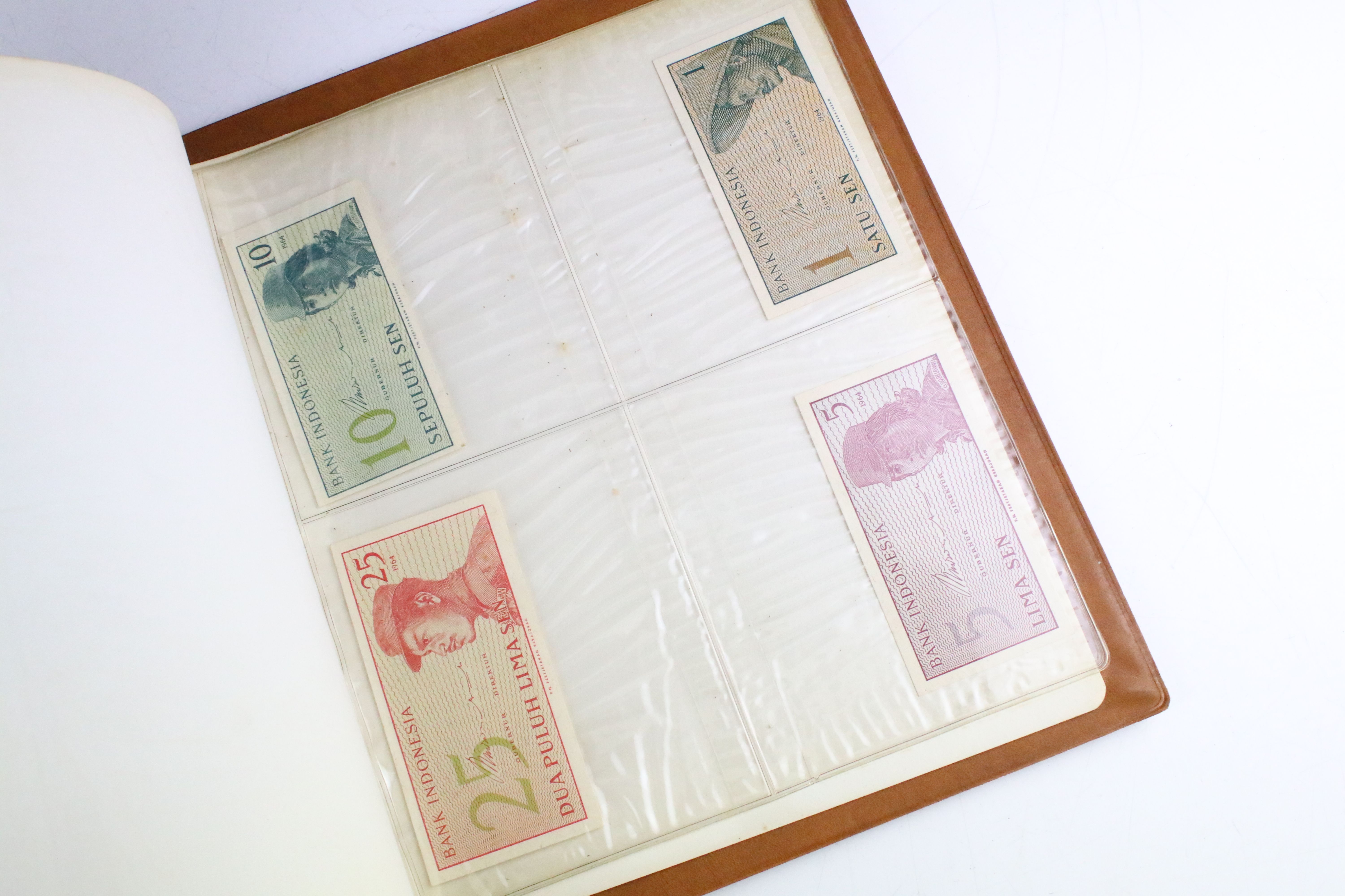 A small collection of British and World banknotes contained within a collectors album. - Image 9 of 9