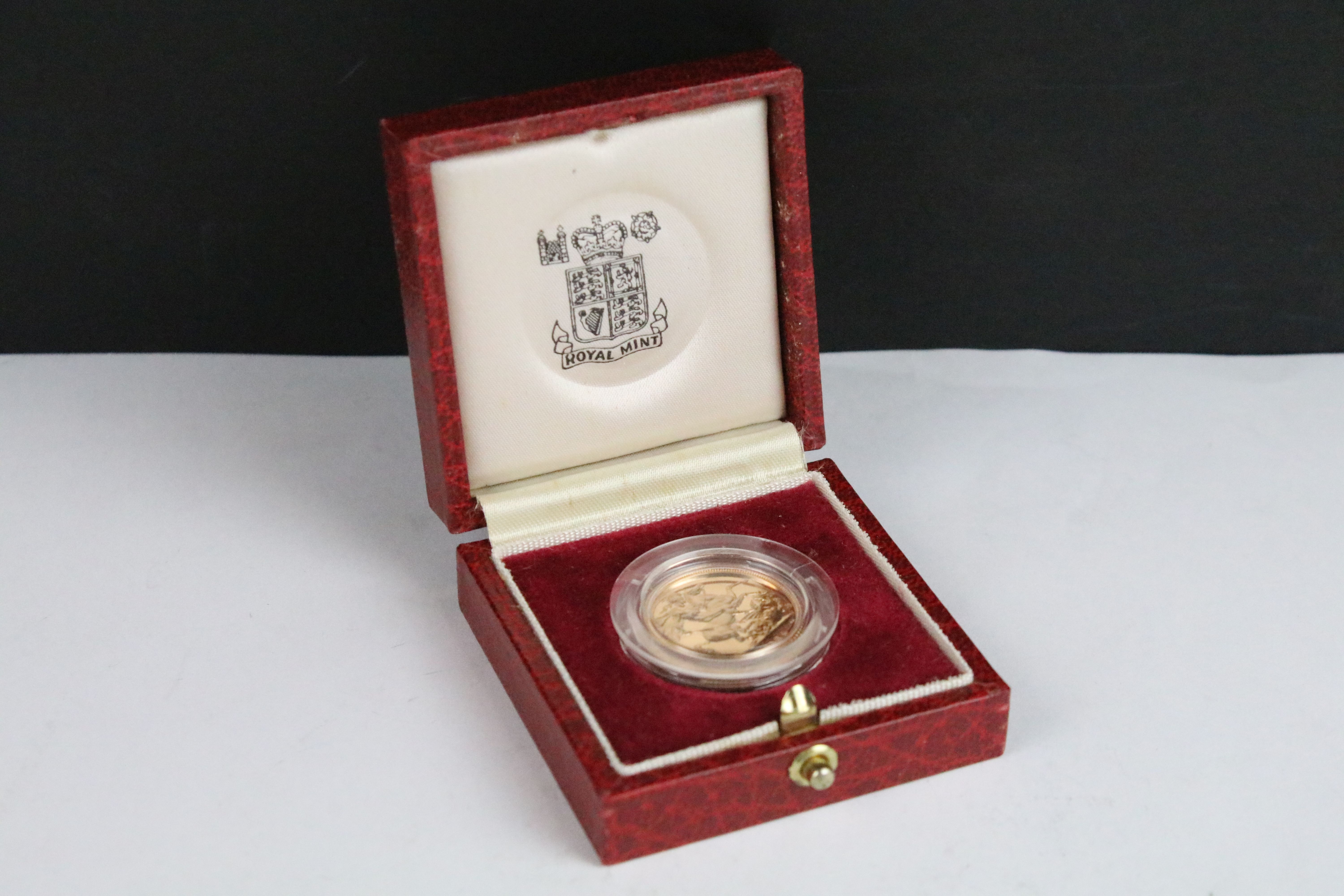 A British Royal Mint Queen Elizabeth II proof 1984 gold full sovereign coin encapsulated within