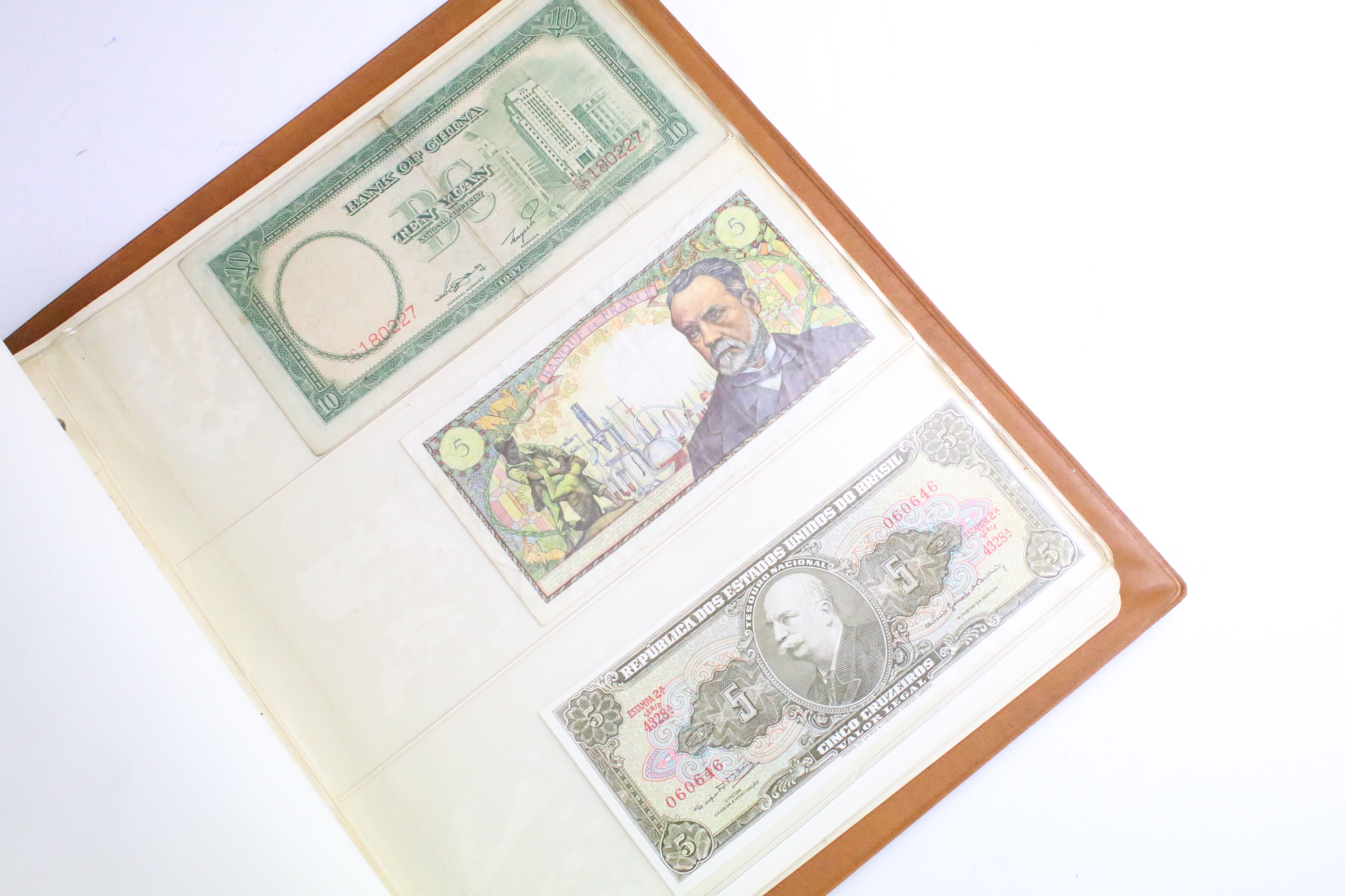 A small collection of British and World banknotes contained within a collectors album. - Image 6 of 9