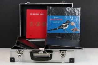 A collection of empty coin collectors albums contained within an aluminium storage case.