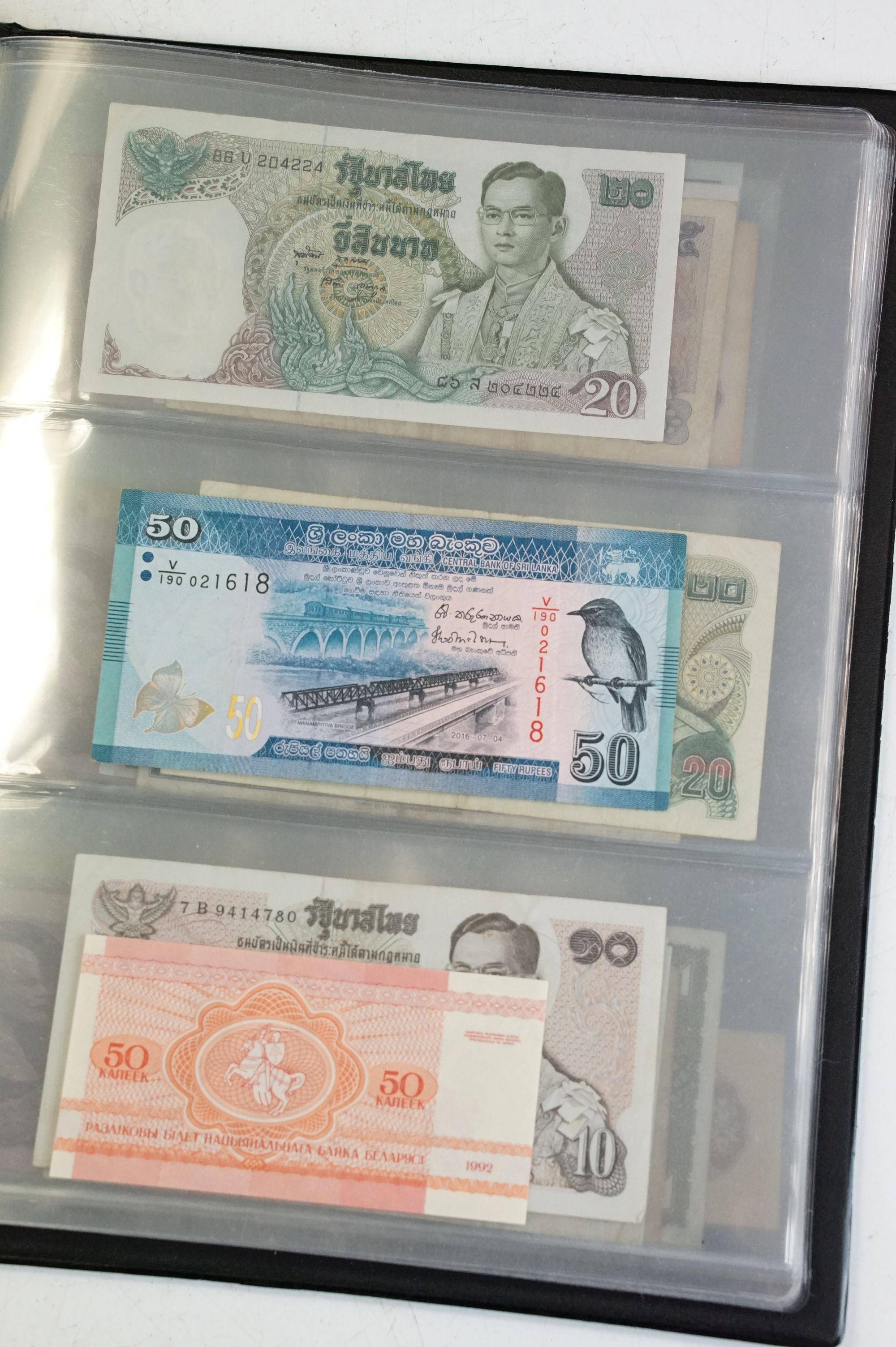 A collection of circulated and uncirculated world banknotes within a collectors folder to include - Image 8 of 12