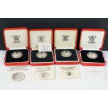 A collection of four Royal Mint silver proof £1 coins to include 2002, 1985, 1983 and 1988 examples,