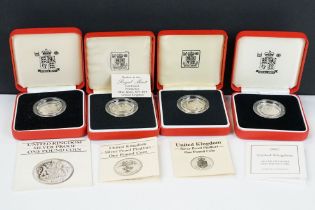 A collection of four Royal Mint silver proof £1 coins to include 2002, 1985, 1983 and 1988 examples,