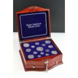 A set of early american silver coins encapsulated within wooden fitted display case.