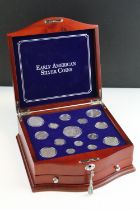 A set of early american silver coins encapsulated within wooden fitted display case.