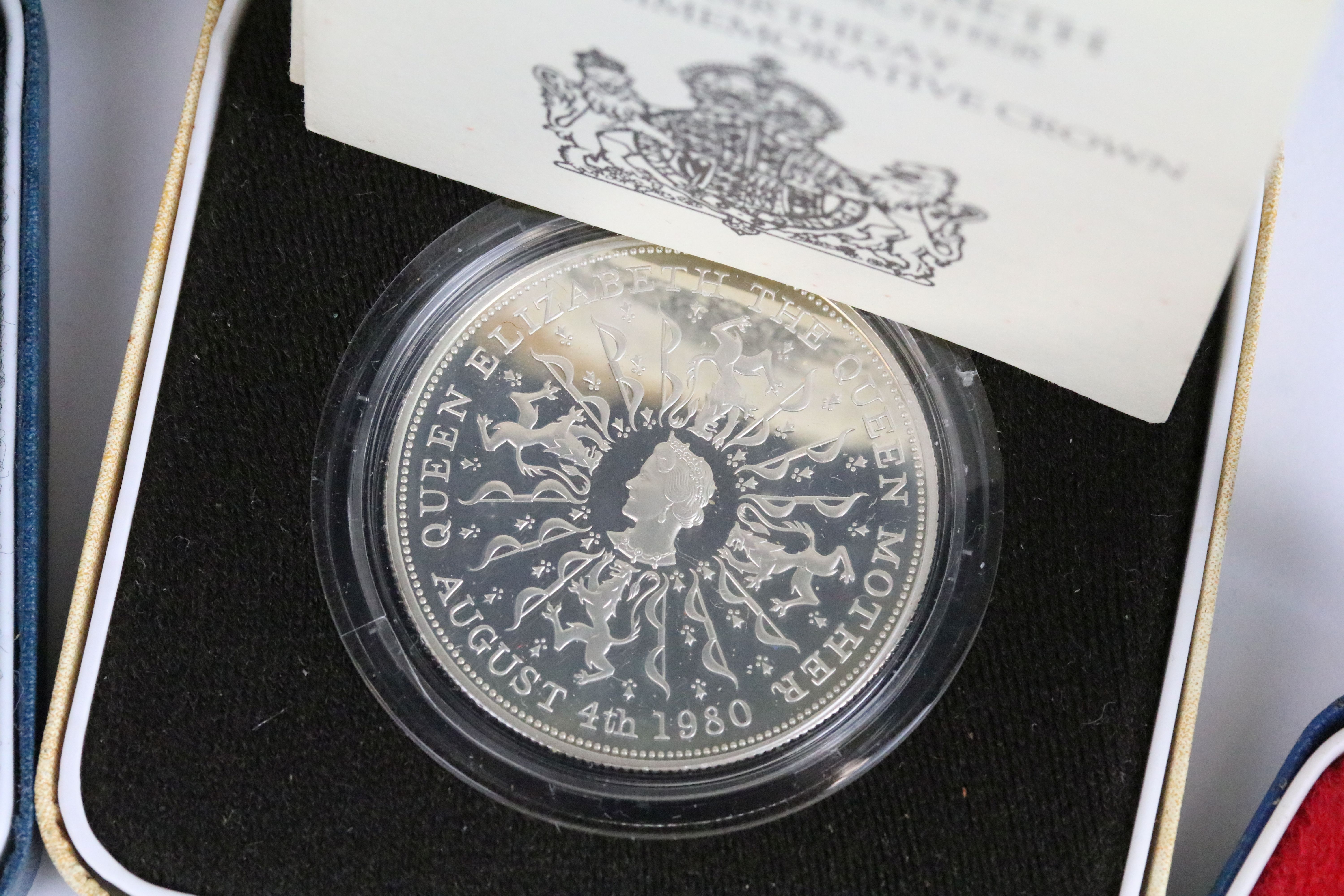 A collection of four Royal Mint silver proof crown coins all encapsulated within display cases. - Image 7 of 9