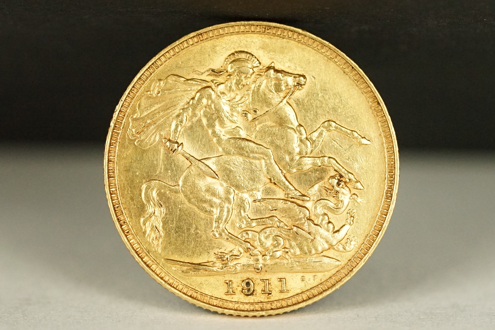 A King George V 1911 gold full sovereign coin with Sydney Mint mark.