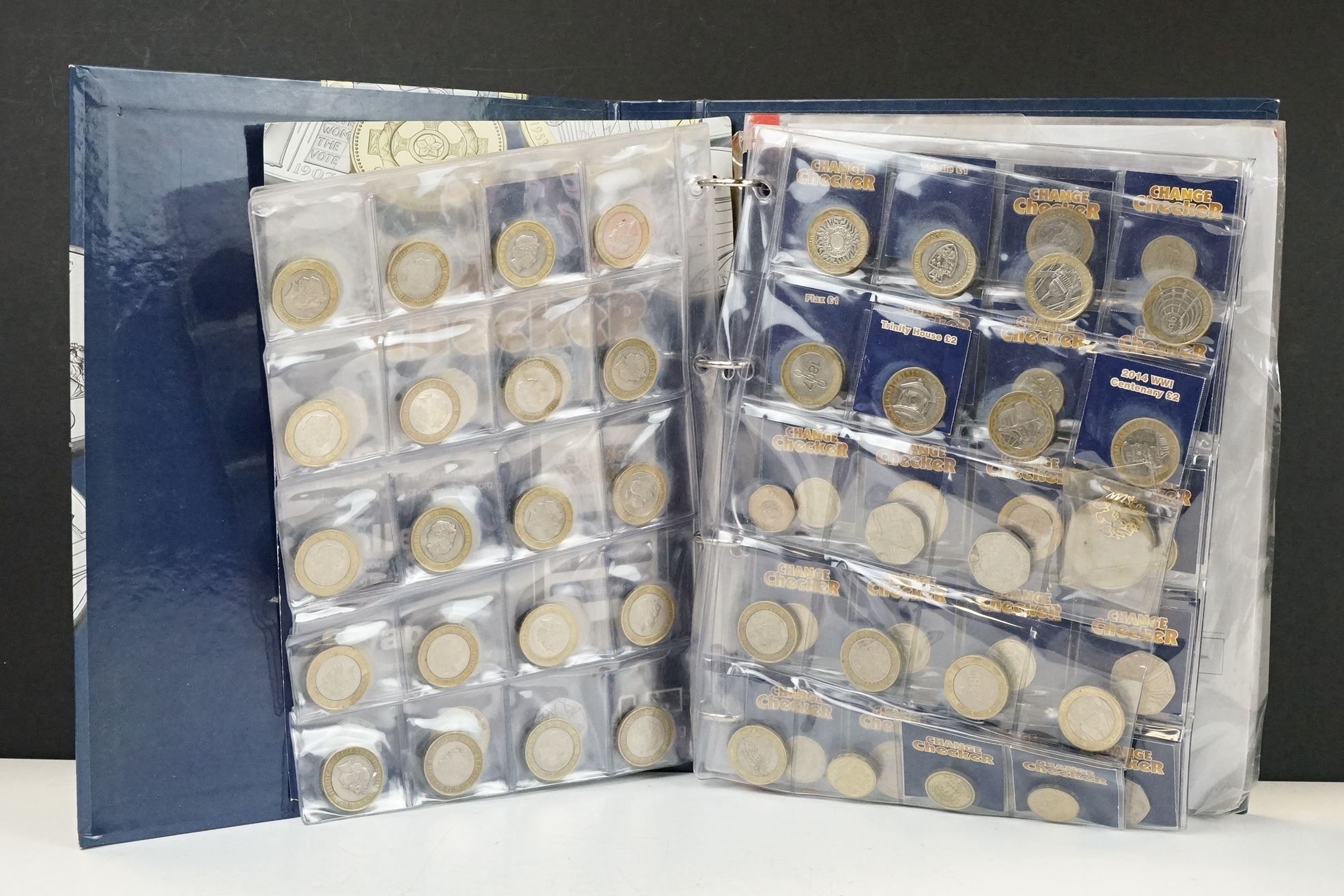 A collection of British decimal collectable £2, £1 and 50p coins contained within a change checker