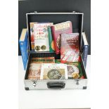 A collection of coin and banknote collectors reference books contained within an aluminium storage