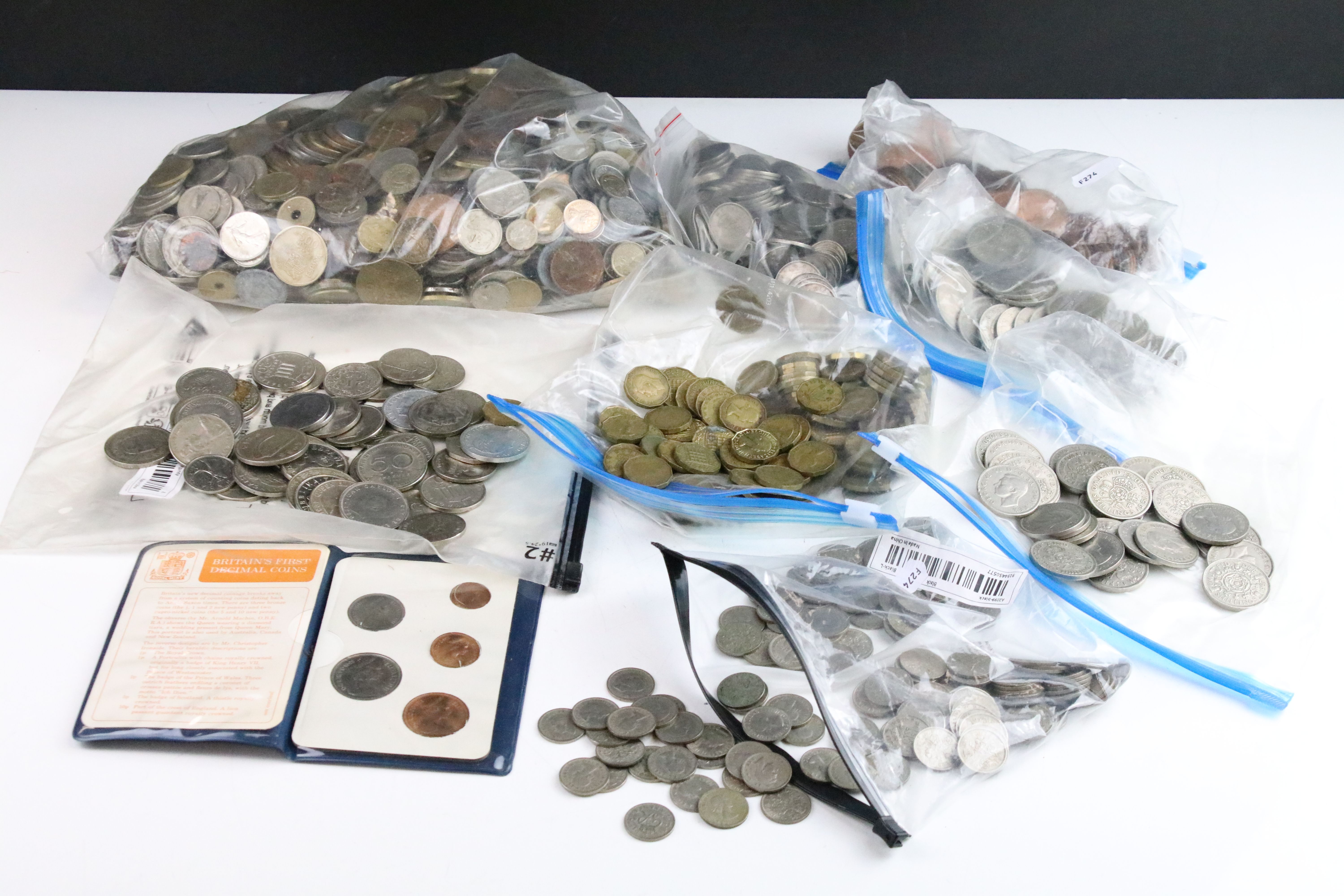 A collection of mainly British pre decimal coins to include half crowns, florins, shillings,