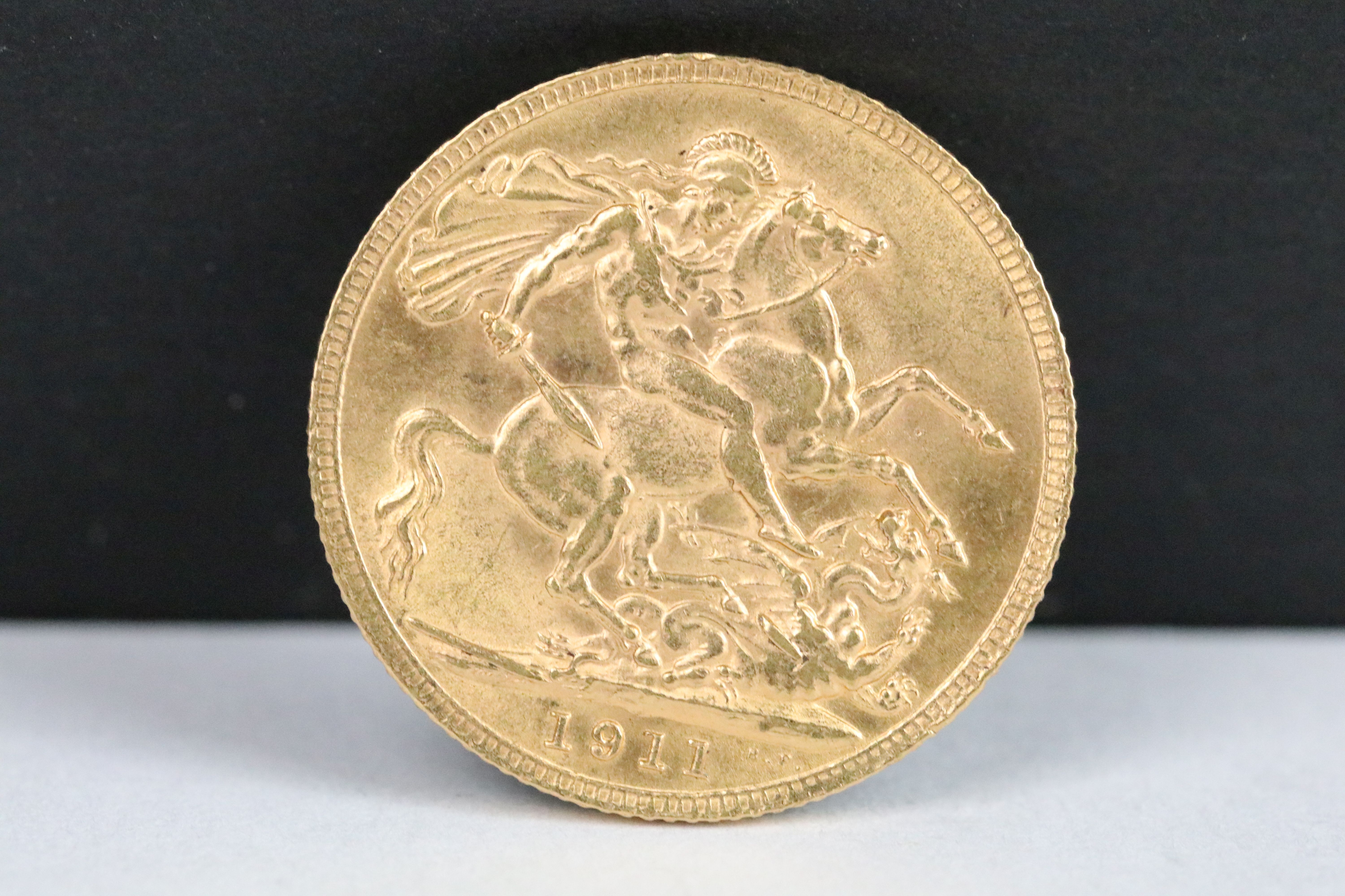 A British King George V 1911 gold full sovereign coin.