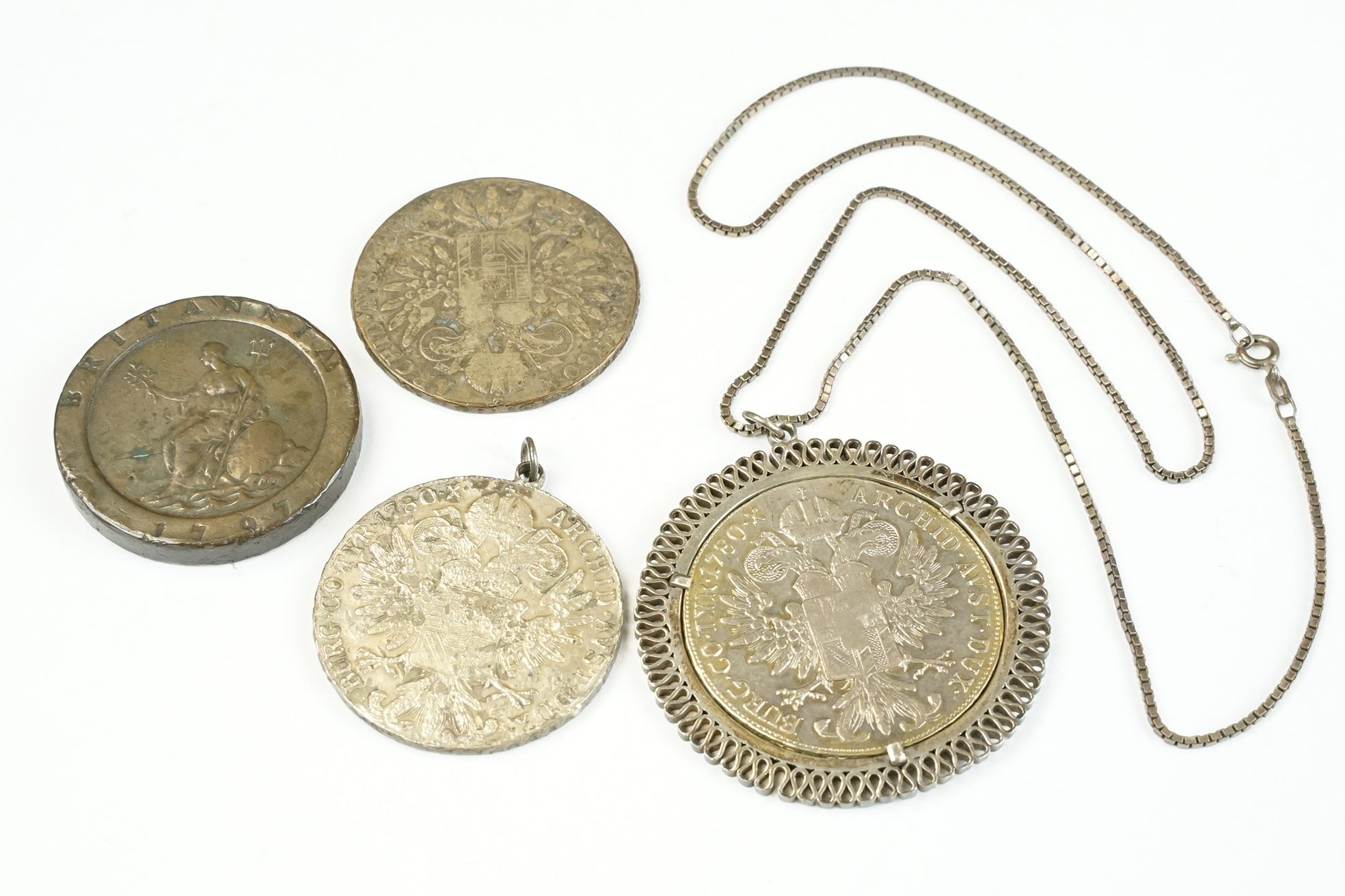 A small collection of four coins to include three 1780 silver Thalers and a British King George