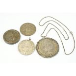 A small collection of four coins to include three 1780 silver Thalers and a British King George