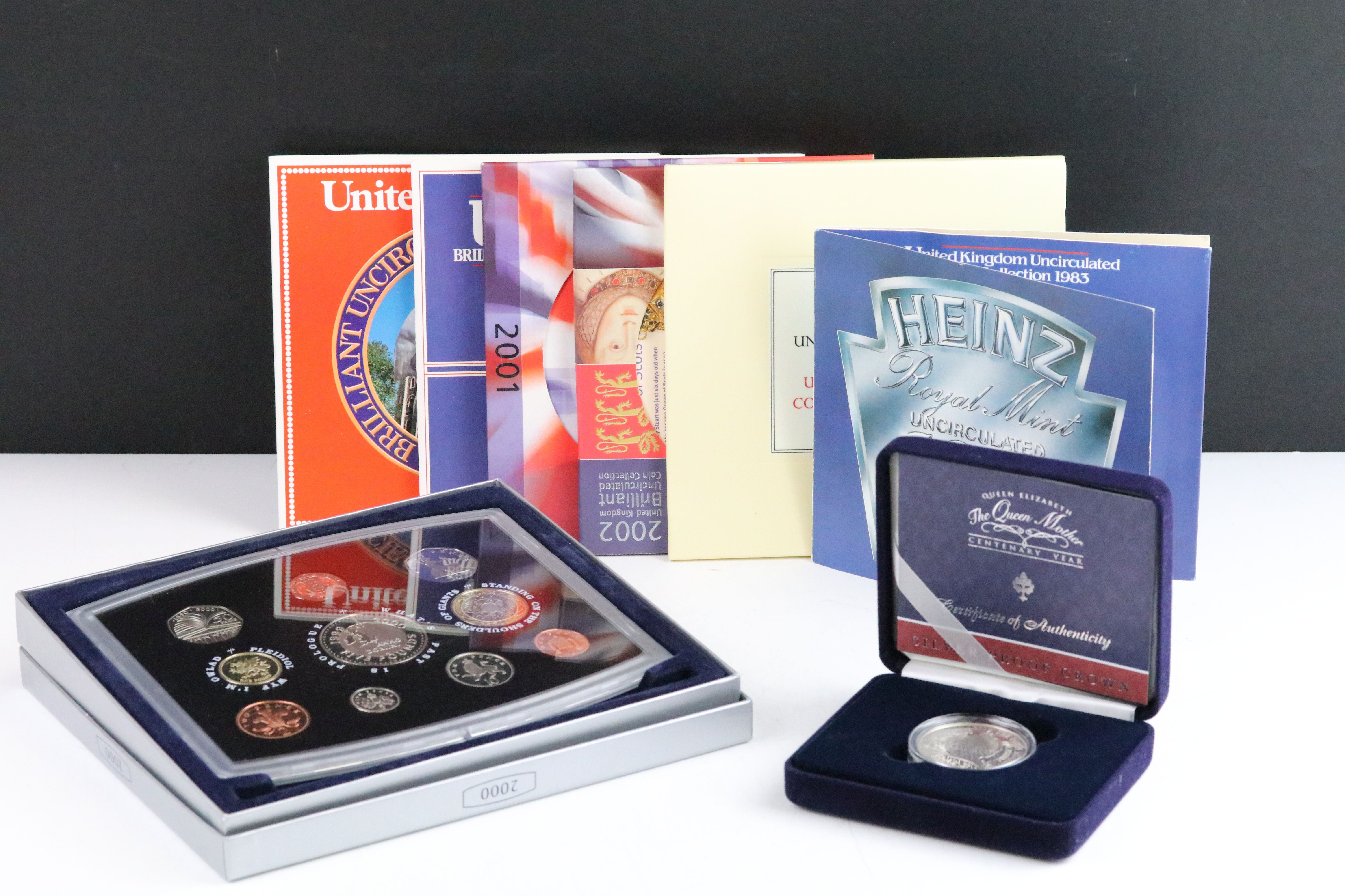 A collection of eight Royal Mint uncirculated coin year sets to include 2000, 2001, 2002, 1986,