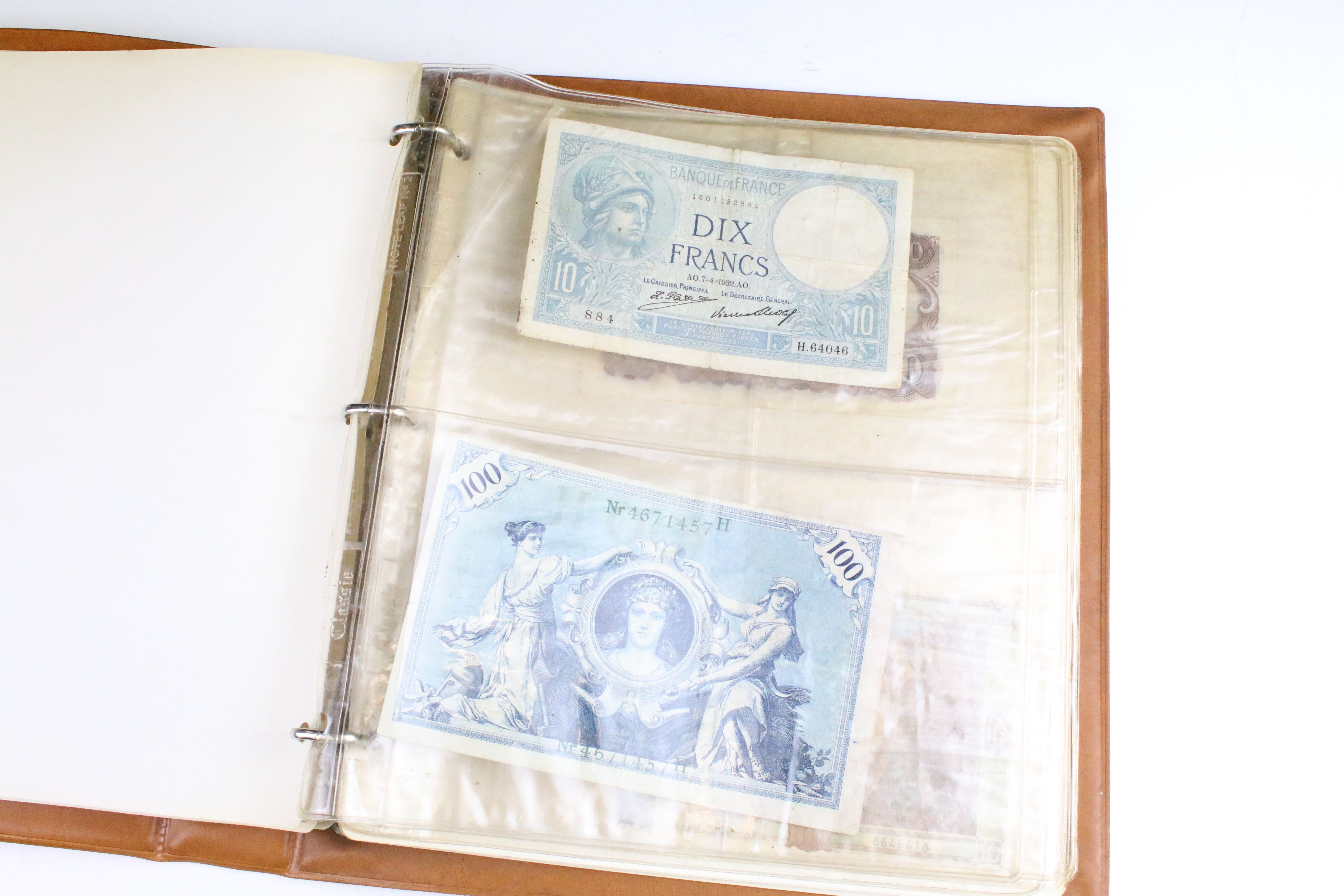 A small collection of British and World banknotes contained within a collectors album. - Image 4 of 9