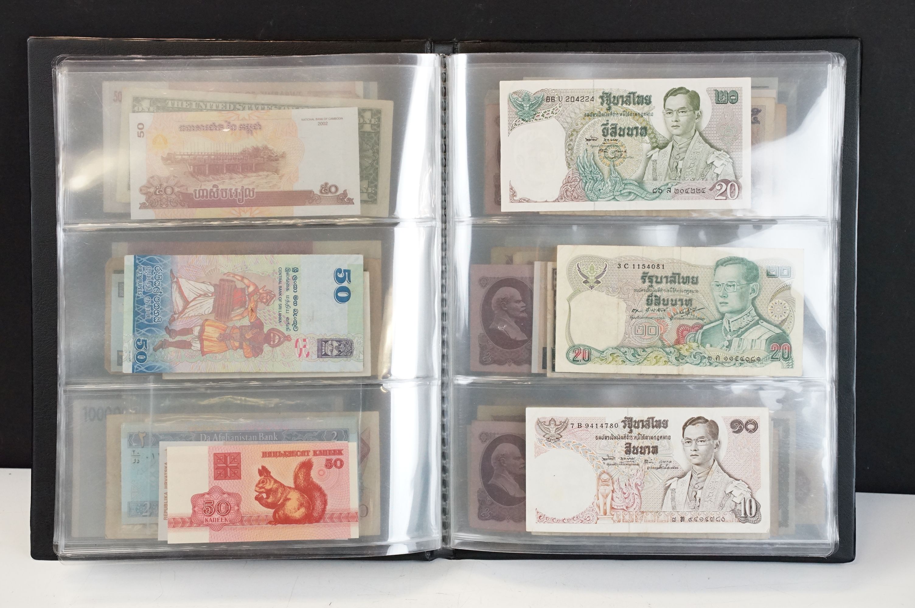 A collection of circulated and uncirculated world banknotes within a collectors folder to include