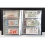 A collection of circulated and uncirculated world banknotes within a collectors folder to include