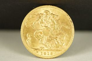 A British King George V 1913 gold full sovereign coin.