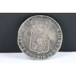 A British William & Mary 1689 silver half crown coin.