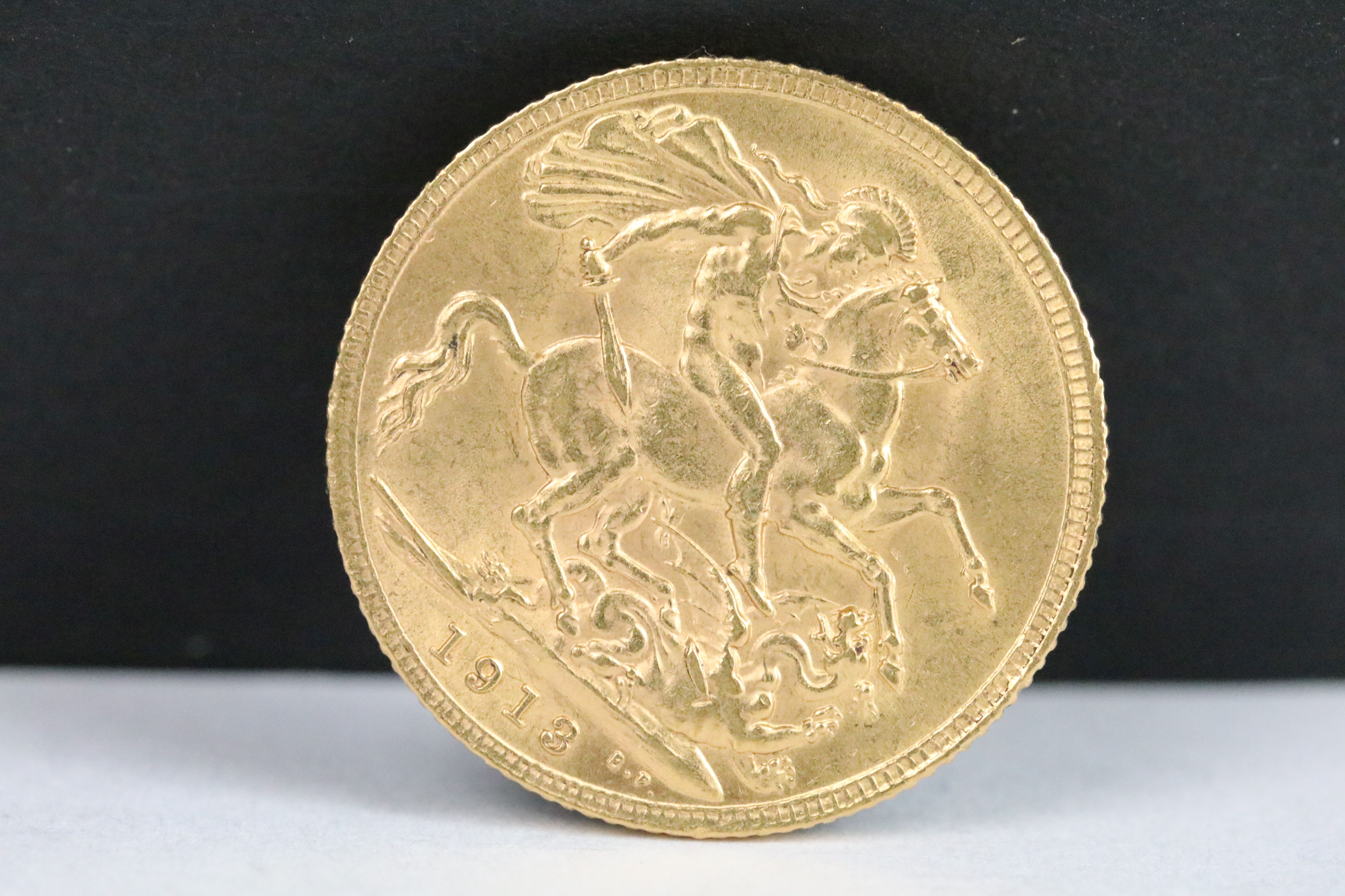 A British King George V 1913 gold full sovereign coin.