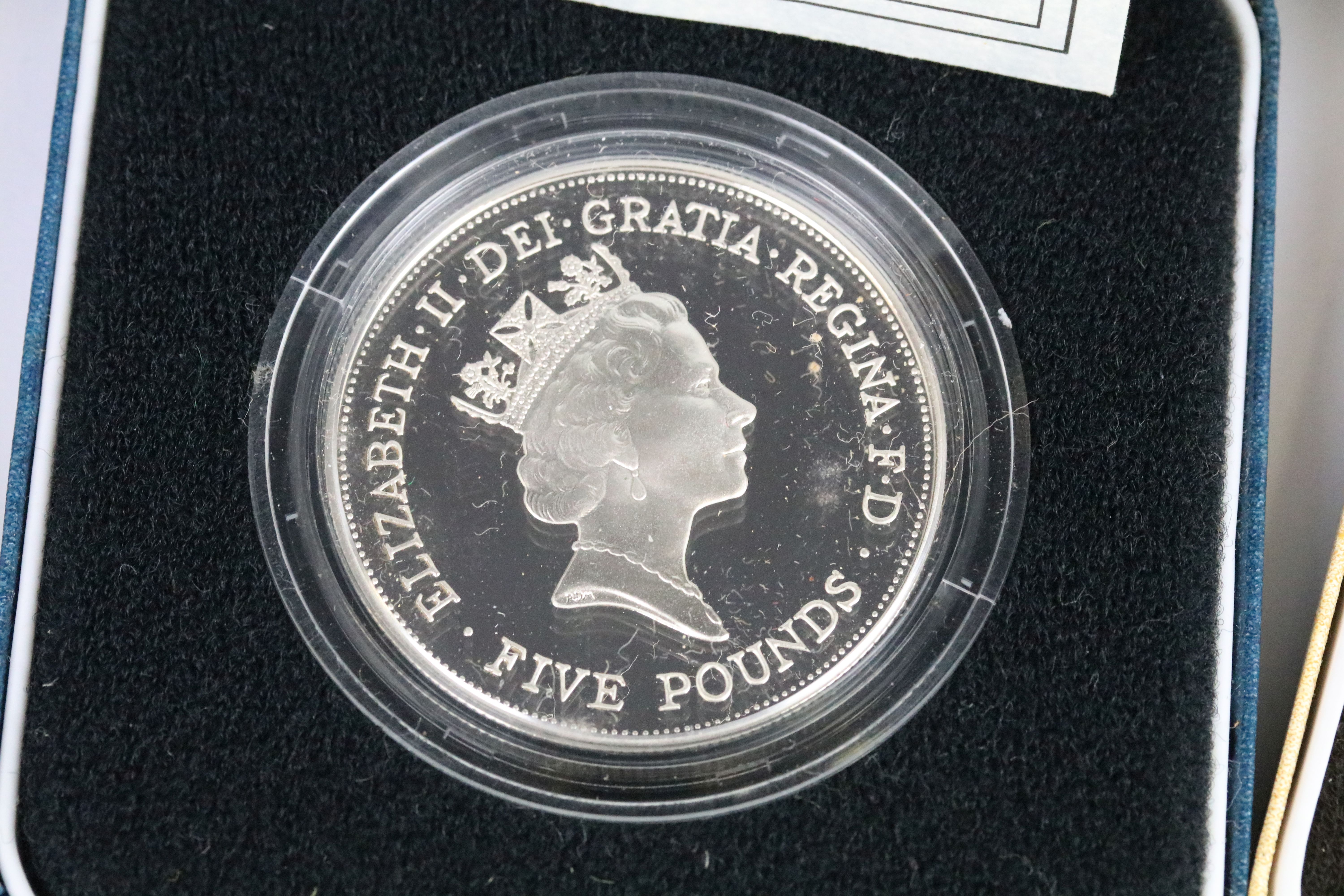 A collection of four Royal Mint silver proof crown coins all encapsulated within display cases. - Image 5 of 9