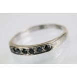 18ct white gold and sapphire half eternity ring. The ring being set with seven round cut sapphires