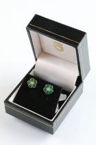 Pair of 9ct gold emerald and diamond cluster earrings. The earrings set with a round cut diamond