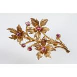 20th Century 9ct gold and ruby floral spray brooch. The brooch set with seven round cut rubies