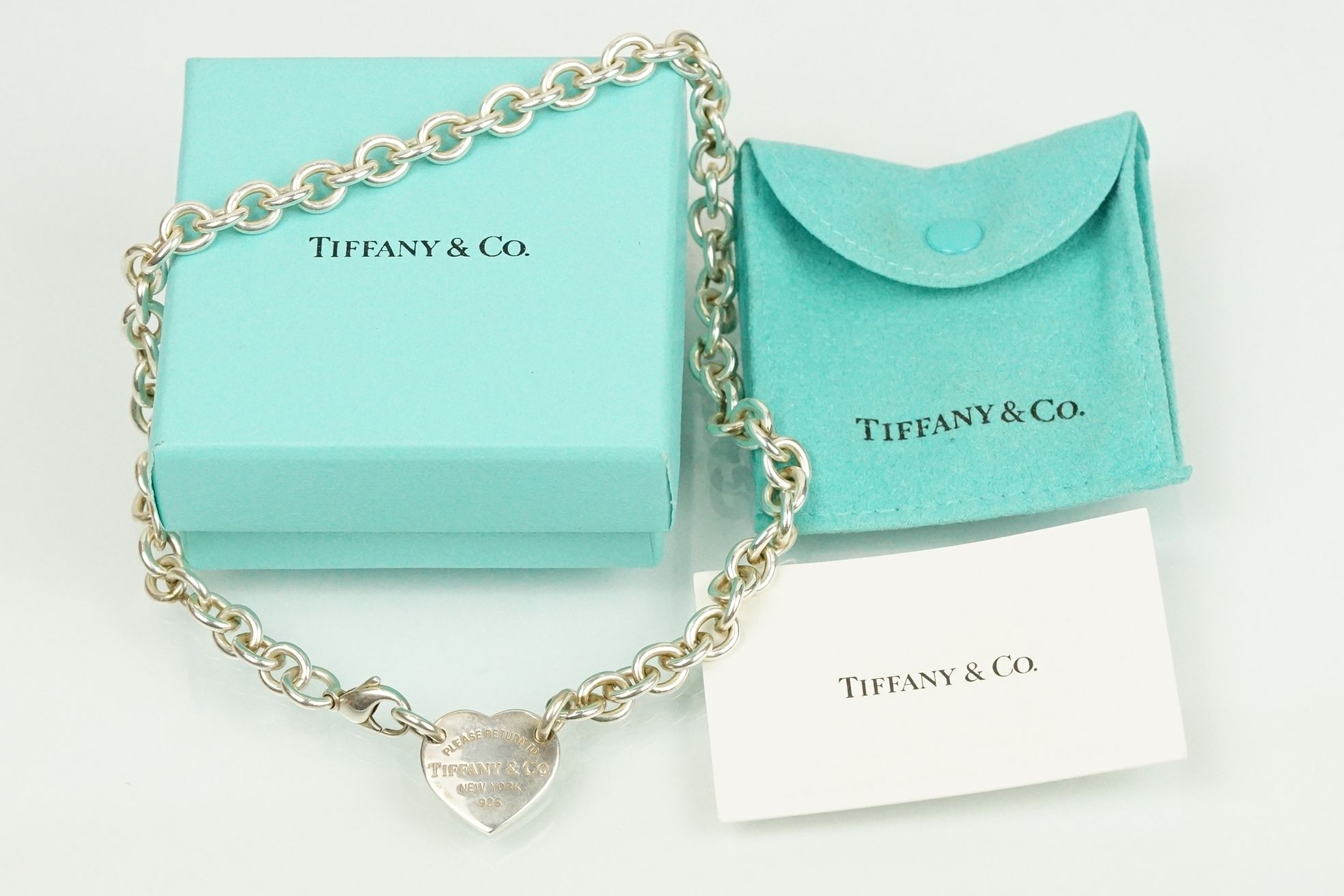 Tiffany & Co 'please return to ' pendant necklace having a heart shaped panel engraved Tiffany & Co.