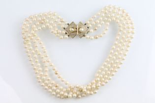 Christian Dior - Four strand simulated pearl necklace having a white stone set clasp with half
