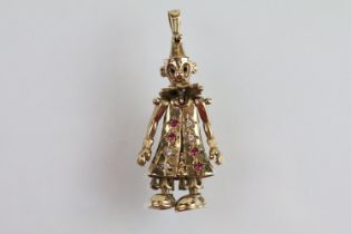 9ct gold hallmarked clown pendant with articulated limbs set with round cut rubies and diamonds.