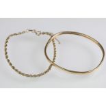 Two hallmarked 9ct gold bracelets to include a bangle of plain design (hallmarked Birmingham), and a